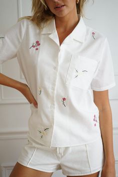 Made with two luxurious pieces, the Primavera Set is a matching collared shirt and drawstring shorts set. Complete with embroidered daisies and petunias intentionally placed along both shirt and shorts. Breezy linen texture Collared neckline with center-front buttons Adjustable waist for flexible fit Two piece set Pintuck vertical seam detail on shorts 40% polyester, 40% rayon, 20% linen As shown: Clara is 5'11" wearing size S. Free returns for store credit that never expires. Your order will sh Embroidered Daisies, Shirt And Shorts, Linen Texture, Collared Shirt, Casual Sets, Pin Tucks, Petunias, Drawstring Shorts, Two Piece Set