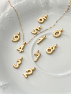 I'm sure you've noticed a theme, but we love personalized jewelry pieces. Select a number or date of significance to you and wear it close to your heart everyday. 14kt Matte gold plated silver number Charm Size: 14mm h x 2mm thick Gold filled chain 18 inches Arrives in gift box To see more please visit my shop at https://www.etsy.com/shop/BijouLimon Customizable Gold Charm Necklaces For Birthday, Gold Charm Name Necklace For Anniversary, Gold Initials Name Necklace For Birthday, Gold Initial Pendant Necklace For Birthday, Gold Name Necklace With Charms For Anniversary, Gold Initial Necklace For Birthday, Classic Gold Charm Necklace For Anniversary, Gold Charm Necklace With Custom Name For Anniversary, Personalized Gold Charm Necklace For Birthday