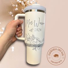 a hand holding a white coffee mug with the words, mrs and mr written on it