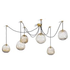 five glass globes hanging from a wire on a white wall in an art deco style