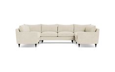 a white sectional couch sitting on top of a white floor