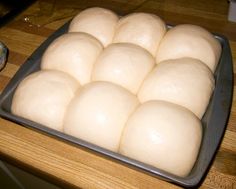 a pan filled with dough on top of a wooden table