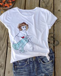 This t-shirt is unique, aesthetic and painted by artist me with a special acrylic and a brush. It also includes  some embroidery and patchwork by stitching fabrics. Express yourself with a one-of-kind aesthetic style just like I do with my painting. This shirt is purely made in USA SIZE: S   Chest: 16"   Length:21" Care of goods machine wash in cold water delicate cycle color separate tumble dry low do not bleach Relaxed Fit Cotton Tops With Custom Artwork, Cotton Tops With Custom Artwork For Summer, Summer Cotton T-shirt With Custom Artwork, Summer Graphic Tee With Custom Artwork, Casual Summer Tops With Custom Artwork, Hand Printed Graphic Tee For Summer, Artsy Cotton Top With Screen Print, Hand Printed White T-shirt For Summer, White Hand-printed T-shirt For Summer