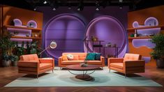 an orange couch and two chairs in front of a purple wall with shelves on it