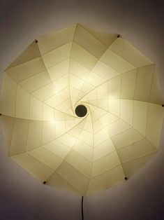 a light that is on top of a lamp shade in the dark room with dim lighting