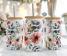 three ceramic jars with floral designs on them