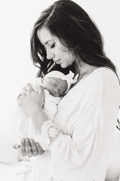 a woman holding a baby in her arms