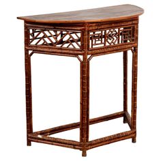 a wooden table with an intricate design on the top and bottom shelf, against a white background