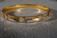 I am offering you this fabulous vintage yellow gold and silver tone Fancy etched raised relief bangle bracelet . It is a bangle bracelet, that has wonderful shape to it, with a very nice profile. It is bold measuring app. 2 1 /2 inches in diameter. It is a bit under 1/2 inches wide, and domed, adding so much extra interest and allure to this fabulous bangle bracelet. Buyer pays shipping and handling. Vintage Bangle Bracelets, Stackable Jewelry, Sterling Silver Wedding Band, Vintage Bangles, Silver Wedding Bands, Bezel Set Diamond, Silver Bangle Bracelets, Jewelry Bracelet, Dream Jewelry