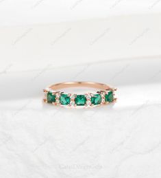 an emerald and diamond ring on white background