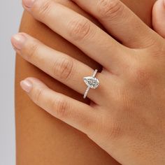 a woman's hand with a diamond ring on it