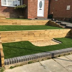 an outdoor area with artificial grass and steps