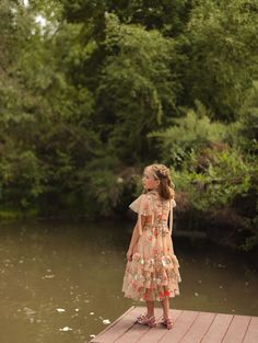 Step into a fairytale with the Garden Party Dress, where enchanting tan, pink, and green tulle layers weave a storybook dream. The sweetheart neckline and delicate flutter sleeves with charming bows make you feel like a princess, while the ruffle-tiered ankle-length skirt is perfect for twirling at any magical gathering. This dress if fit for a queen! fairytale dress, gown dresses elegant, garden party, garden dress, mommy & me dress, princess aesthetic Summer Princess Fairy Dress For Garden Party, Whimsical Fairy Dress With Ruffles For Garden Party, Whimsical Ruffled Fairy Dress For Garden Party, Spring Fairy Dress With Ruffles For Dress-up, Whimsical Ruffled Fairy Dress For Dress-up, Whimsical Fairy Dress With Ruffles For Dress-up, Spring Fairy Dress With Ruffles For Garden Party, Princess Style Ruffled Dresses For Garden Party, Princess Style Dress With Ruffles For Garden Party