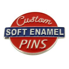 a red and blue pin with the words custom soft enamel pins