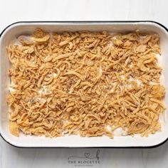 an uncooked casserole dish filled with macaroni and cheese