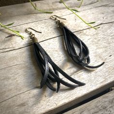 "-These tassel earrings are made from soft black deerskin leather. Part Western, part Boho, part Rock 'n Roll, these little fringe earrings give a big kick to any outfit. -Lightweight enough to wear every day. -3\" - 3.5\" total length, including earwires. -Earwires are antique-brass. -Deerskin leather is sustainably sourced in the USA. -Ok to get wet. -Available in 10 colors. -Designed and handmade in South Pasadena, CA. Check out more of our awesome earrings here: https://www.etsy.com/shop/AST Handmade Black Leather Earrings, Black Leather Drop Earrings, Adjustable Leather Tassel Earrings, Awesome Earrings, Black Earring, Earring Small, Fringe Earring, Biker Babe, Tassel Earring