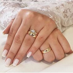 two women's hands with wedding rings on their fingers