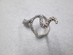 "Nicely detailed slithering SNAKE ring, size 7 as shown, but can be slightly adjusted. Almost 1 3/4\" long, this vintage 70's silvertone snake ring is a rarity, and we only have a few different styles of snake jewelry left...they go fast! You're going to love this one! New old stock, in great vintage condition. Check out our other snake jewelry listings!" Silver Metal Snake-shaped Ring, Silver Metal Open Snake Ring, Silver Open Snake Ring, Slithering Snake, Silver Emerald Ring, Snake Jewelry, Blowout Sale, Palm Beach Fl, Snake Ring