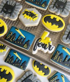 decorated cookies with batman themed icing on cooling racks