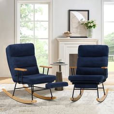 two blue rocking chairs sitting in front of a fire place next to a table with a vase on it