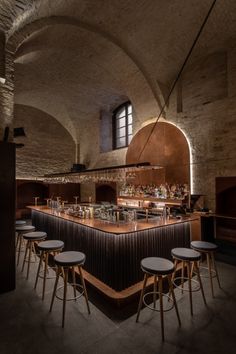 an empty bar with stools in front of it