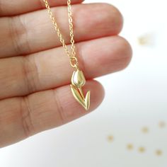 "Beautiful and lovely gold Tulip charm necklace. Made of a matte gold finish Tulip charm with a skinny gold plated brass chain. Soft and simple. Great for gift, everyday or special occasion. Your item will ship in a gift box. Please feel free to contact me if you have any questions. ♥ Length 14\" - 20\" chain ♥ Tulip charm 3/8\" x 5/8\" long ♥ Gold plated over brass ♥ See more Rudiana Accessories Rudiana.etsy.com" Tulip Necklace Aesthetic, Everyday Gold Charm Necklaces With Flower Charm, Gold Minimalist Charm Necklaces With Flower Charm, Minimalist Gold Charm Necklace With Flower Charm, Gold Minimalist Flower Charm Necklace, Minimalist Gold Necklace With Flower Charm, Gold Dainty Charm Necklace For Mom, Dainty Gold Charm Necklace For Mom, Minimalist Gold Charm Necklace For Birthday