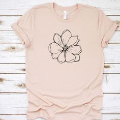 Our shirts are handmade in Ohio by hand with love and care one at a time. We hope you will find a shirt that will inspire you or someone else. DESCRIPTION: Magnolia, Magnolia Shirt, Floral Tee, Magnolia Tee, Wildflower Shirt, Boho Shirt, Garden Shirt, Magnolia Tshirt, Summer Shirt, Flower Shirt This cute magnolia tee is a must. We use a high-quality unisex t-shirt that is insanely soft. In fact, it will be one of the softest, best fitting, most comfortable shirts you've ever owned. CLICK BELOW h Spring Graphic Tee With Screen Print, Spring Graphic Tee Shirt With Screen Print, Summer Floral Print T-shirt For Everyday, Floral Print T-shirt For Summer, Spring Everyday T-shirt, Simple Crew Neck Shirt For Spring, Spring Everyday Printed T-shirt, Botanical Screen Print T-shirt For Spring, Summer Floral Graphic Tee