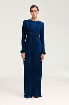 Indulge in the splendor of the Samara Pleated Wrap Waist Maxi Dress in Lapis Blue. This luxurious dress features an elegant plisse satin fabric, artfully pleated wrap waist, and a feminine ruffle hem. Elevate your style with this exquisite piece. Model is 5'7" and is wearing size XS/58". Pleated Satin Dress, Luxurious Dress, White Dress Formal, Dresses Flowy, Nikkah Dress, Makeup Wishlist, Luxurious Dresses, Lapis Blue, Engagement Dresses