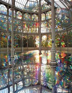 the inside of a building with lots of windows and colorful stained glass on the ceiling