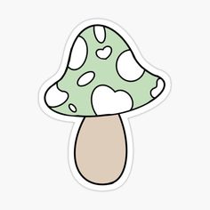 a green and white mushroom sticker with hearts on it's cap, sitting on top of a table