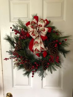 a christmas wreath hanging on the front door