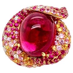 This gorgeous cabochon pink tourmaline ring is custom made that is designed to capture everyone's attention. The pink and yellow sapphires are scattered along with the round brilliant diamonds to give the ring a strawberry shortcake appearance. The translucent pink tourmaline captivate the eyes and this is a must have ring for you collection. Size: 6.25 (can be resize) Tourmaline and Sapphires: 28.81 cts, Cabochon / Round Diamonds: 0.71 ct, Round Brilliant Metal: 18k Rose Gold Pink Diamond Ring, Ring Rosegold, Bath And Body Works Perfume, Jewelry Real, Pink Tourmaline Ring, Rose Gold Pink, Gold Ring Sets, 18k Yellow Gold Ring, Tourmaline Ring