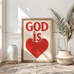 a poster with the words god is above it and a potted plant next to it