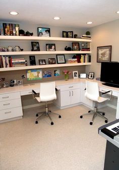 a home office with two white chairs and a piano in the middle of the room