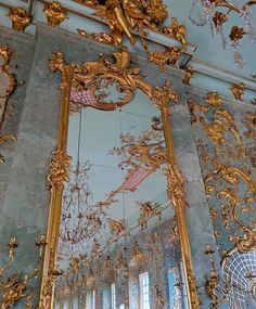 an ornately decorated room with mirrors and chandeliers