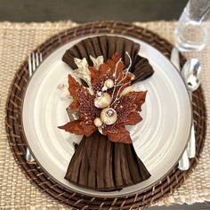 a white plate topped with a leaf and flower decoration