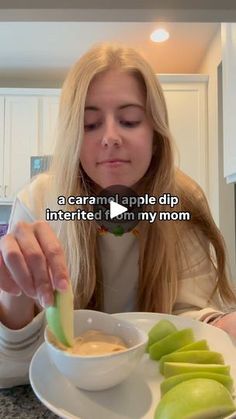 a woman sitting at a table with some food in front of her and the caption reads, a caramel apple dip interrupted by my mom