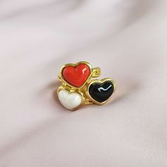 Made from delicate porcelain, this ring features a pearly white heart-shaped centrepiece that captures the essence of love and romance. The sheen of the mother-of-pearl coating reflects light beautifully. The organic pearly patterns adds a touch of purity and beauty, making it a perfect accessory for any occasion. The heart is encased in a 18K gold-plated setting and a braided band.  MATERIAL Handmade porcelain  18K Gold-plated brass    SIZE & FIT Ring size: EU 54/US 7 Ring diameter: 17. 2mm Pro Gold Enamel Heart Ring For Anniversary, White Enamel Anniversary Rings, White Heart Ring For Gift, White Enamel Elegant Rings, Elegant White Enamel Ring For Gift, Heart-shaped Enamel Ring For Anniversary, White Elegant Enamel Rings, Elegant White Enamel Rings, White Rings With Heart Charm For Valentine's Day