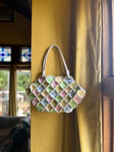 Beautiful 1970's Leather Crochet Patchwork Handbag in yellow, blue, pink and green pastels.  Intricate crochet detailing and floral tooling, This whimsical piece will dress up any outfit to make it more interesting! The interior and exterior are both super clean, working zippers. One handle is slightly discolored more pink than the other white one. Size: 15.5" wide  9.5" high Strap length: 8" Vintage Crochet Bag For Spring, Vintage Multicolor Handmade Crochet Bag, Multicolor Handmade Vintage Crochet Bag, Vintage Multicolor Crochet Bag For Everyday Use, Vintage Multicolor Crochet Bag For Daily Use, Vintage Multicolor Square Crochet Bag, Pastel Handbags, Patchwork Handbag, Leather Crochet