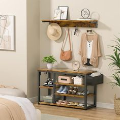 there is a shelf with shoes and purses on it next to a bed in the room