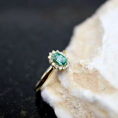 18K Emerald and Brilliant Diamonds Engagement Ring, 0.45ct Natural Emerald Gold Ring, 18K Brilliant Diamonds Wedding Ring, Gift For Her ⚜️Weight: 6.0gr   💎Gemstone: Emerald 0.45ct  💎Gemstone: 14 Diamonds of 0.15ct each Beautiful and unique 18K gold Diana emerald ring set with 1 emerald and 14 small diamonds.  🦚 Visit my gemstone rings collection:  https://www.etsy.com/shop/noahconcept/?etsrc=sdt&fbclid=PAAabX3la4ZzrGRug-fdx0AVTcM8lpjsQHSMDfEzyRu4du-woM_ISVKRQy-x4_aem_AX0rENIVkOuE6tb8lFnkZ-I7L1xhLyAzS9jU5bKkczHscuq2Zk93UMLbmGnlinC5MBA&section_id=43942909 The jewelry you buy from NoahConcept are delivered in ♻️ eco friendly boxes with the brand name on the top. If you want to wrapped as gift please let us know. *Small changes in the jewelry prices may occur depending on the price of the m Emerald Cluster Ring With Brilliant Cut Diamonds, Emerald Cut Diamond Birthstone Ring With Halo Setting, Emerald Cluster Ring With Halo Design For Promise, Fine Jewelry Yellow Gold Emerald Ring With Halo Design, Yellow Gold Emerald Ring With Halo Design, Emerald Halo Design Wedding Ring, Cluster Diamond Emerald Ring, Emerald Diamond Ring With Halo Design For Promise, Emerald Rings With Diamond White Halo Setting