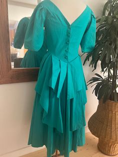 This is a stunning and rare Laura Ashley bustle back dress from the early 80s.  In exquisite condition and a perfect size 8. Green Puff Sleeve Dress For Wedding, Fitted Bodice Green Dress With Ruffles, Vintage Puff Sleeve Midi Dress For Party, Vintage Victorian Ruffled Evening Dress, Vintage Victorian Evening Dress With Ruffles, Vintage Victorian Dress With Ruffles For Evening, Vintage Evening Dress With Ruffles And Fitted Bodice, Green Fitted Victorian Dress For Formal Occasions, Green Fitted Victorian Dress For Formal Events