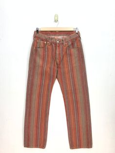 Vintage Levis Jeans Red Stripe Levis 501 Denim Pants - BS47597.  Manual Measurement (laying in flat area):  1) Waist: 34 inch.  2) Rise: 10.5 inch.  3) Hips: 22.5 inch.  4) Tight: 12 inch.  5) Outseam: 44 inch.  6) Inseam: 33 inch.  7) Leg opening: 9 inch.  Made in: JAPAN.  Fabric Material: 100% Denim Cotton.  Condition: In good vintage condition overall.  Please check all the measurement to insyre a proper fit.  Remember to allow yourself some extra room for movement.  You can compare these information with your favourite pants too.  BS47597.  We do combining shipping.  Please Read Before Purchase. Drop your phone number. Tracking number can be tracked 3 - 5 days after shipment process. Please be patient waiting. This design and style by wearing it increases your confidence. All pieces ar Casual Multicolor Full-length Jeans, Multicolor Full Length Jeans For Fall, Multicolor Full-length Jeans With Pockets, Vintage Baggy Straight Leg Jeans, Multicolor Straight Leg Relaxed Fit Jeans, Vintage Baggy Pants With Five Pockets, Brown Relaxed Fit Vintage Jeans, Retro Relaxed Fit Faded Bottoms, Vintage Relaxed Fit Bottoms With Five Pockets