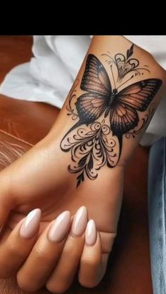 a woman's foot with a butterfly tattoo on it