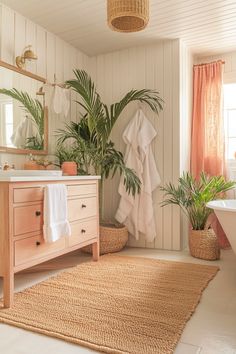 a bathroom with plants and towels on the wall