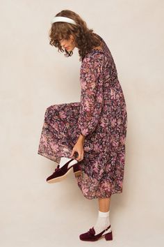 Searching for modest long sleeve dresses? Introducing our Sasha Dress - a playful and flowy addition to your wardrobe. Made with black chiffon fabric and adorned with purple florals, this midi-length women's dress features a square neckline with ruffle detailing, a hidden back zipper, smocking, and ruching. All of these unique details and more make this dress stand out. Perfect for fall and beyond. Bohemian Maxi Dress For Fall With Relaxed Fit, Long Sleeve Floral Print Maxi Dress In Relaxed Fit, Modest Fall Daywear Dress, Casual Flowy Long Sleeve Spring Dress, Flowy Casual Midi Dress For Fall, Flowy Long Sleeve Dress For Casual Spring Occasions, Flowy Modest Maxi Dress For Fall, Modest Flowy Maxi Dress For Fall, Flowy Long Sleeve Dress For Dress Down Spring Events