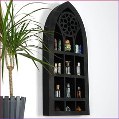 a potted plant sitting next to a black shelf