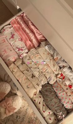 a drawer filled with lots of baby blankets