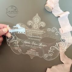 someone is cutting out a wedding card with scissors