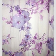 purple flowers on white fabric with beads